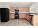 Kitchen with modern appliances, ample counter space, and warm wood cabinetry at 10431 Bellchime Ct, Indianapolis, IN 46235
