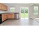 Kitchen with hardwood floors, stainless steel appliances, and views of the lush backyard at 10431 Bellchime Ct, Indianapolis, IN 46235
