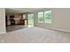 Open concept living room and kitchen area with lots of natural light, carpet, and hardwood flooring at 10431 Bellchime Ct, Indianapolis, IN 46235