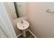 A half-bathroom with a pedestal sink, bright lighting, and modern fixtures provides added convenience for guests at 10431 Bellchime Ct, Indianapolis, IN 46235
