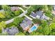 A gorgeous aerial photo that shows the home's pool, deck, patio, and lush yard at 11227 Woods Bay Ln, Indianapolis, IN 46236