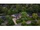 This high angle aerial showcases a beautiful home, lush lawn, and mature trees at 11227 Woods Bay Ln, Indianapolis, IN 46236