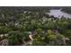This high angle aerial shows the neighborhood's mature trees and nearby lake at 11227 Woods Bay Ln, Indianapolis, IN 46236