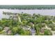 A stunning aerial view shows a beautiful neighborhood nestled among mature trees near a scenic lake at 11227 Woods Bay Ln, Indianapolis, IN 46236