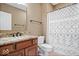 Bathroom with a dark wood vanity, granite countertop, modern fixtures, and decorative shower curtain at 11227 Woods Bay Ln, Indianapolis, IN 46236