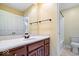 Bathroom with white countertop, wooden cabinets, large mirror, and a shower at 11227 Woods Bay Ln, Indianapolis, IN 46236