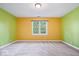 Bright bedroom featuring multi colored walls, a gray carpet, and a window that provides natural light at 11227 Woods Bay Ln, Indianapolis, IN 46236
