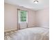 Bright bedroom featuring neutral walls, a gray carpet, and a window that provides natural light at 11227 Woods Bay Ln, Indianapolis, IN 46236