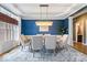 Bright dining area featuring a modern chandelier and beautiful blue accent wall at 11227 Woods Bay Ln, Indianapolis, IN 46236
