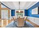 Elegant dining room with blue walls, chandelier, and stylish furnishings at 11227 Woods Bay Ln, Indianapolis, IN 46236