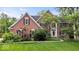 Beautiful two-story brick home with well-maintained lawn and mature trees at 11227 Woods Bay Ln, Indianapolis, IN 46236