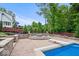 Poolside fire pit with retaining walls and landscaping offers a place to relax and enjoy the outdoors at 11227 Woods Bay Ln, Indianapolis, IN 46236