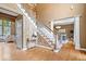 Inviting foyer with hardwood floors, staircase, and elegant architectural details at 11227 Woods Bay Ln, Indianapolis, IN 46236