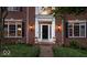 Close-up of front entrance with black door, sidelights, and elegant sconces at 11227 Woods Bay Ln, Indianapolis, IN 46236