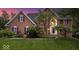 Charming red brick home with manicured lawn and lush landscaping at 11227 Woods Bay Ln, Indianapolis, IN 46236