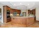 Kitchen island with granite countertops, stainless steel appliances, and custom wood cabinets at 11227 Woods Bay Ln, Indianapolis, IN 46236