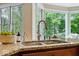 Kitchen sink with stainless steel fixtures, granite countertops, and a view of the outdoors at 11227 Woods Bay Ln, Indianapolis, IN 46236