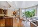 Open kitchen with granite countertops, stainless steel appliances, and an adjacent sitting area at 11227 Woods Bay Ln, Indianapolis, IN 46236