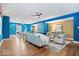 Open-concept living room with hardwood floors, stylish furnishings, and large windows for natural light at 11227 Woods Bay Ln, Indianapolis, IN 46236