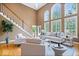 Bright living area with hardwood floors, tall windows and staircase at 11227 Woods Bay Ln, Indianapolis, IN 46236