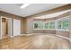 Open living area featuring wood floors and large windows for natural light at 11227 Woods Bay Ln, Indianapolis, IN 46236