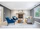 Cozy living room with fireplace, comfortable seating, and natural light at 11227 Woods Bay Ln, Indianapolis, IN 46236