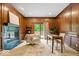 Wood-paneled office featuring a fireplace, desk, and natural light from a door to the outside at 11227 Woods Bay Ln, Indianapolis, IN 46236