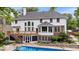 Expansive rear exterior featuring a deck, walkout basement, and a swimming pool for outdoor enjoyment at 11227 Woods Bay Ln, Indianapolis, IN 46236