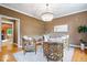 Cozy sitting area with unique chairs, chandelier, and hardwood floors at 11227 Woods Bay Ln, Indianapolis, IN 46236
