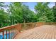 A wooden deck overlooks an in-ground pool surrounded by lush landscaping at 11227 Woods Bay Ln, Indianapolis, IN 46236