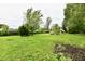 Large, level backyard with lush greenery, offering plenty of space for relaxation and play at 11309 N County Road 750 W, Elwood, IN 46036