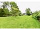 Lush backyard with mature trees, shrubs, and plenty of space, perfect for gardening and relaxation at 11309 N County Road 750 W, Elwood, IN 46036