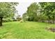 Spacious backyard with a mix of trees and open lawn, ideal for outdoor gatherings and recreation at 11309 N County Road 750 W, Elwood, IN 46036