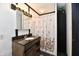 Bathroom featuring granite countertop, wooden vanity, and floral patterned shower curtain at 11309 N County Road 750 W, Elwood, IN 46036