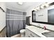 Well-lit bathroom with a modern vanity, framed mirror, and a shower with stylish curtain at 11309 N County Road 750 W, Elwood, IN 46036