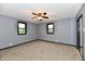 Bedroom featuring two windows, gray walls, and carpeted flooring at 11309 N County Road 750 W, Elwood, IN 46036