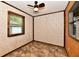 Bedroom featuring wood trim, a window with blinds, and tile flooring at 11309 N County Road 750 W, Elwood, IN 46036