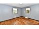Cozy bedroom featuring hardwood floors and two windows offering natural light and outdoor views at 11309 N County Road 750 W, Elwood, IN 46036