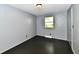 Cozy bedroom featuring a window, gray walls, and dark wood-look flooring at 11309 N County Road 750 W, Elwood, IN 46036