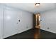 This bedroom has gray walls, dark flooring, a window, and a door to the ensuite bath at 11309 N County Road 750 W, Elwood, IN 46036
