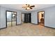 Bedroom with gray walls, carpeted flooring, mirrored closet doors, and access to a bathroom at 11309 N County Road 750 W, Elwood, IN 46036