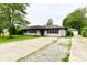 Cozy single-story home with a long, cracked driveway and a detached garage, ready for new memories at 11309 N County Road 750 W, Elwood, IN 46036