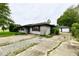 Single-story home featuring a detached two car garage and a cracked concrete driveway at 11309 N County Road 750 W, Elwood, IN 46036