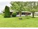 Attractive one-story home with red trim and mature landscaping on a lush green lawn at 11309 N County Road 750 W, Elwood, IN 46036