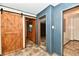 Hallway featuring a barn door and views into multiple rooms at 11309 N County Road 750 W, Elwood, IN 46036