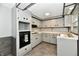 Galley kitchen with gray cabinets and black hardware and a window over the sink at 11309 N County Road 750 W, Elwood, IN 46036