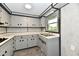 Galley style kitchen, gray cabinets with black hardware, with stainless steel sink at 11309 N County Road 750 W, Elwood, IN 46036