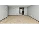 Spacious living room featuring neutral carpet, gray walls and access to the backyard with glass paneled doors at 11309 N County Road 750 W, Elwood, IN 46036