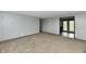 Spacious living room featuring neutral carpet, gray walls and access to the backyard with glass paneled doors at 11309 N County Road 750 W, Elwood, IN 46036