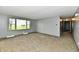 Living room featuring neutral carpet, gray walls and a large window offering natural light and outdoor views at 11309 N County Road 750 W, Elwood, IN 46036
